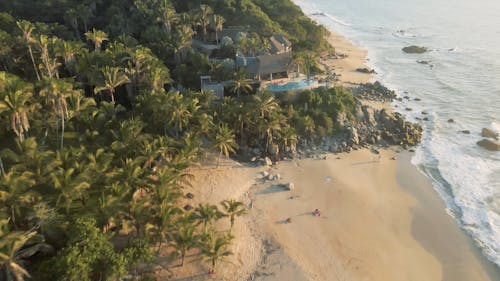 A Drone Footage of a Beach Resort Near the Green Trees
