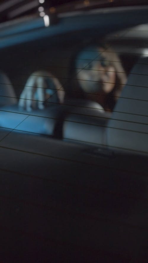 Black Haired Girl Inside Car At Night Posing to Camera