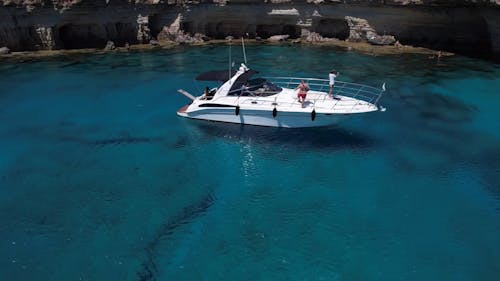 People Riding a White Yacht