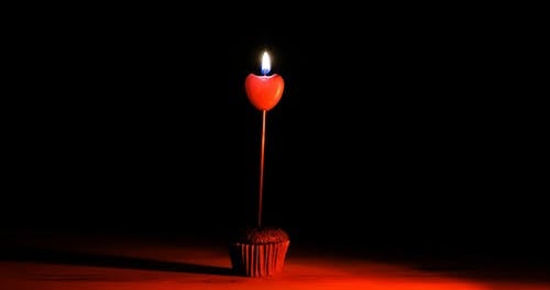 A Heart Shaped Candle on a Cupcake 