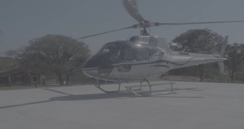 A Helicopter with Engines on and Blades Turning 