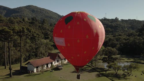 Drone Video of a Red Hot Air Balloon in a Country Club 