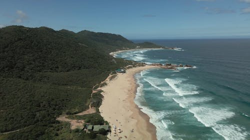 Drone Video of Coastal Green Mountains and a Sandy Beach