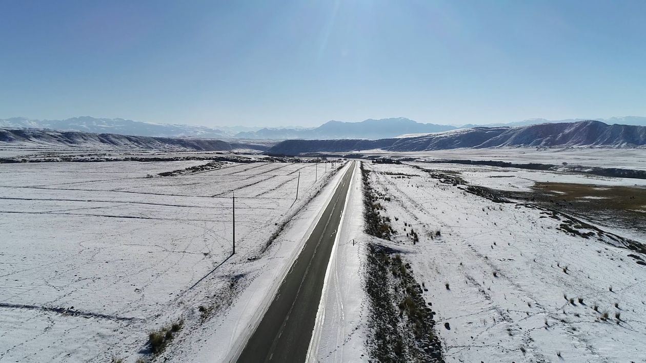 Drone Footage of an Asphalt Road and Snow Covered Land Free Stock Video ...