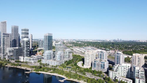 A Drone Footage of a City Buildings Near the Lake