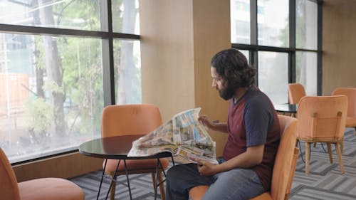 A Bearded Man Reading Newspaper