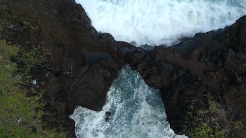 A Drone Footage of Waves Crashing on Rock Formations