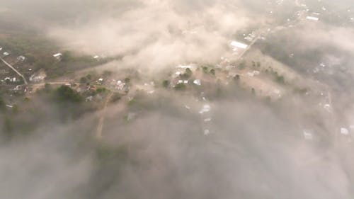 Aerial View of Low Clouds over a Mountain Village  