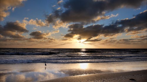 Time Lapse of Moving Clouds over the Beach at Sunset 