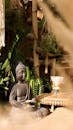 Burning Incense on a Buddha Statue