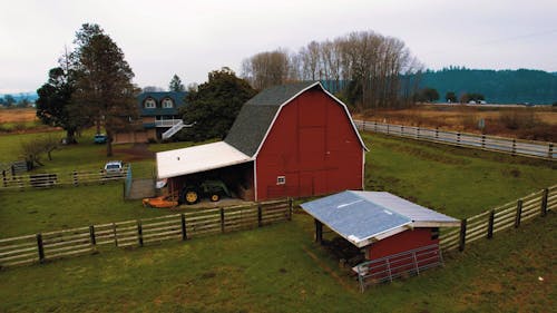 A Tractor Parked near the Barn 