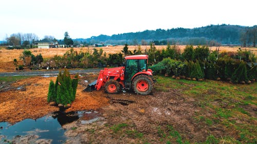 A Tractor in a Muddy Farm Field