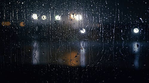 Raindrops Flowing on Glass