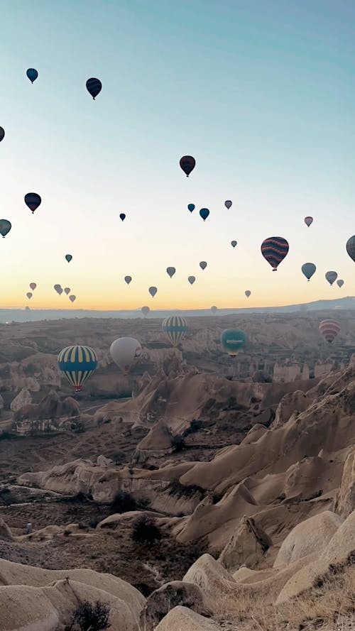 A Hot Air Balloons Flying Over the Rock Formations