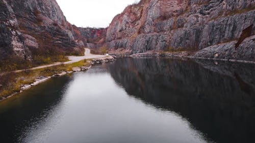 A Drone Footage of a Lake Between Rock Formations