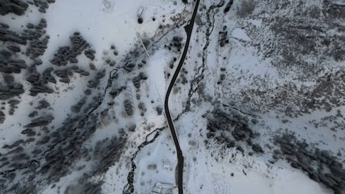 A Drone Footage of a Snow Covered Ground with Trees