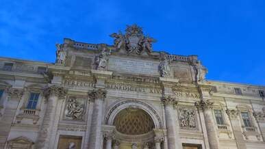 a concrete building near the trevi fountain