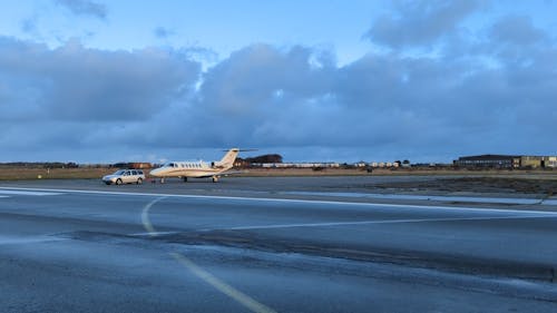 A Car Pulling an Aircraft on the Runway