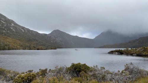 A Lake Between Mountains Under the Cloudy Sky