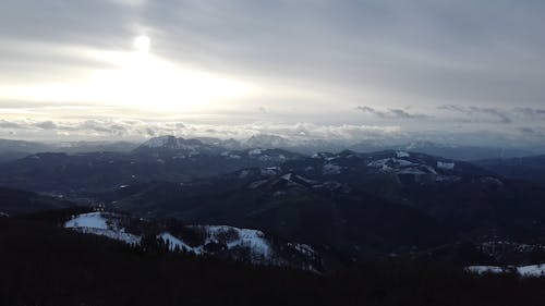 An Aerial Footage of a Mountain Under the Cloudy Sky