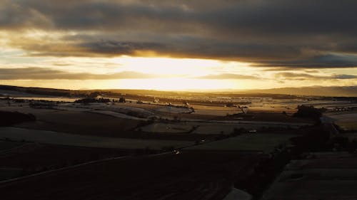 Drone Footage of Bright Sunset over Fields