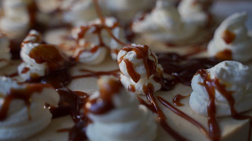 A Close-up Video of a Drizzling Caramel on Top of the Cake with Icing