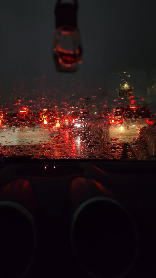 Person Driving a Car on a Rainy Night