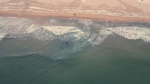 Drone View of Sea Waves and a Sandy Beach 