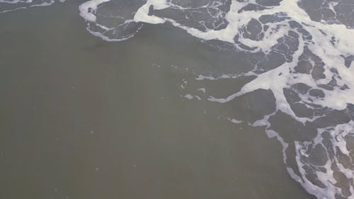 Drone Footage of Breaking Waves and a Sandy Beach 