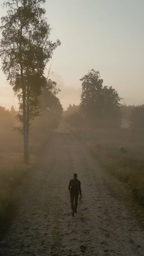 Man Walking on a Dusty Road