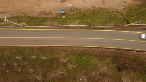 Drone View of a Car Taking a Rural Road 
