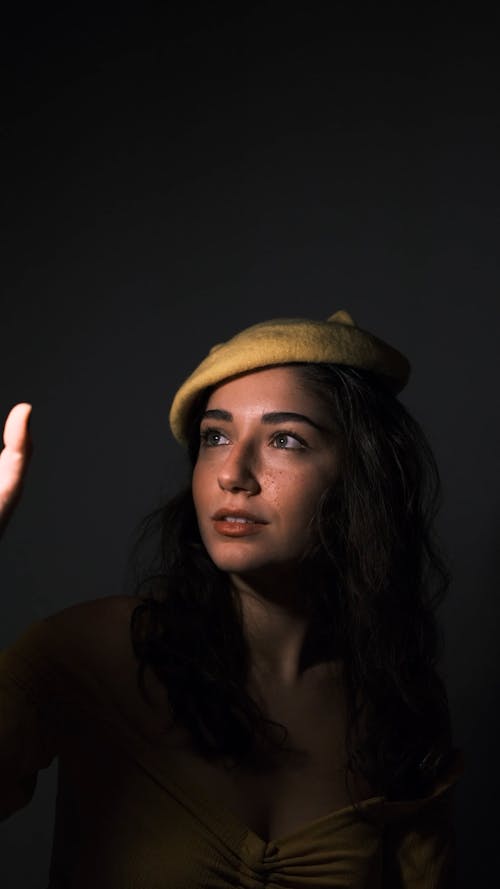 A Smiling Young Woman Wearing a Yellow Beret 