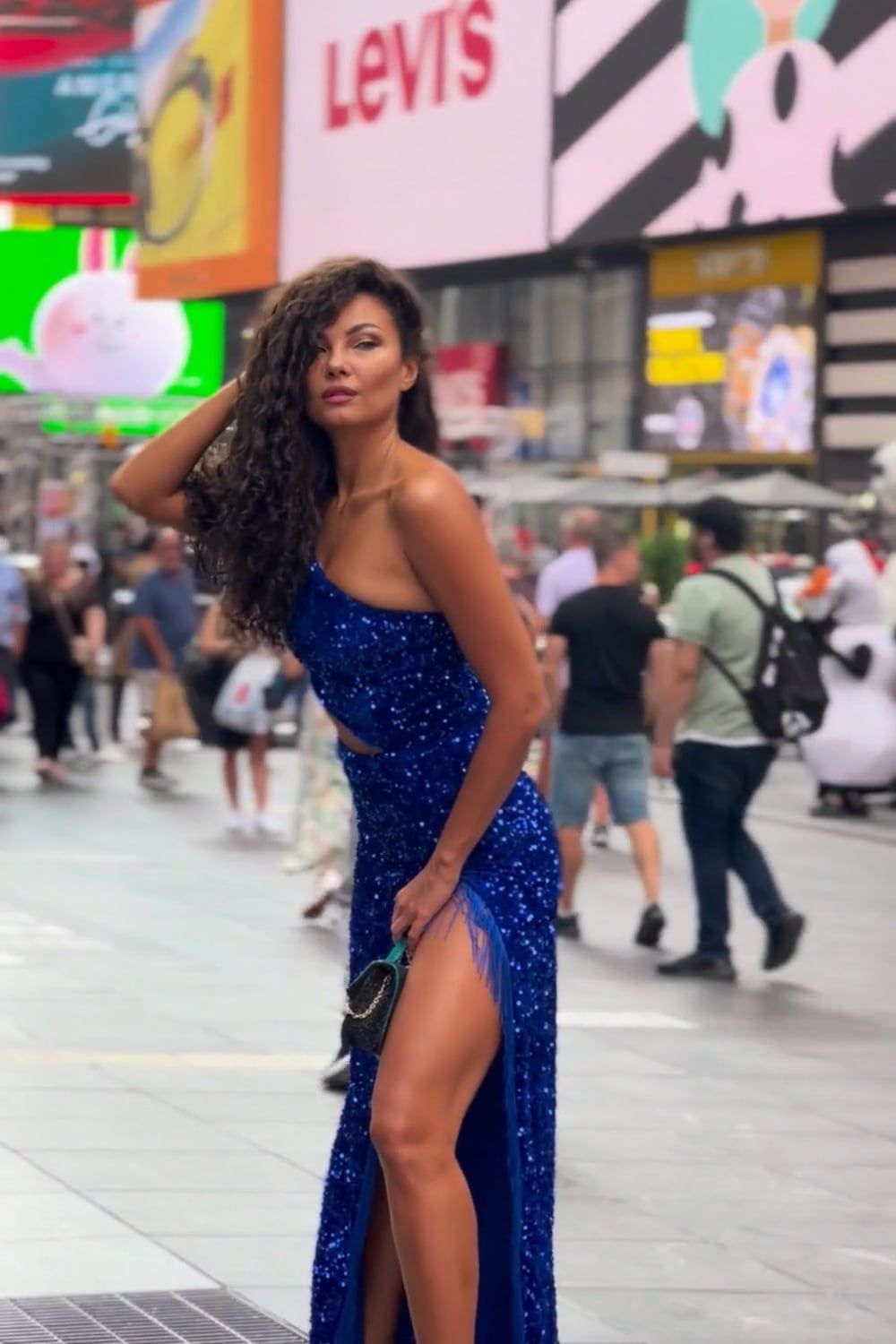 A woman in a blue dress is posing on the street Free Stock Video ...