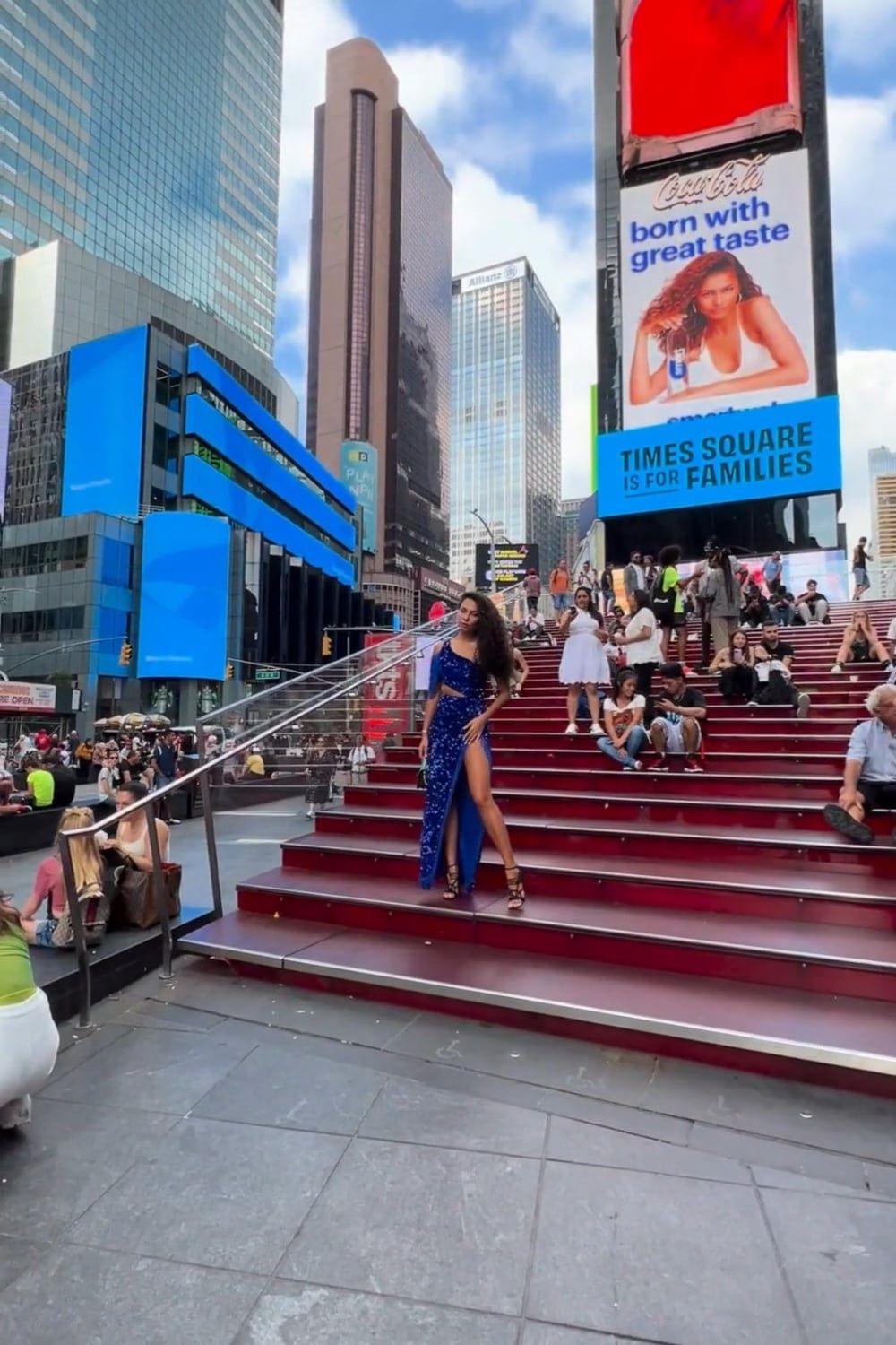 A woman in a blue dress is standing on some steps Free Stock Video ...