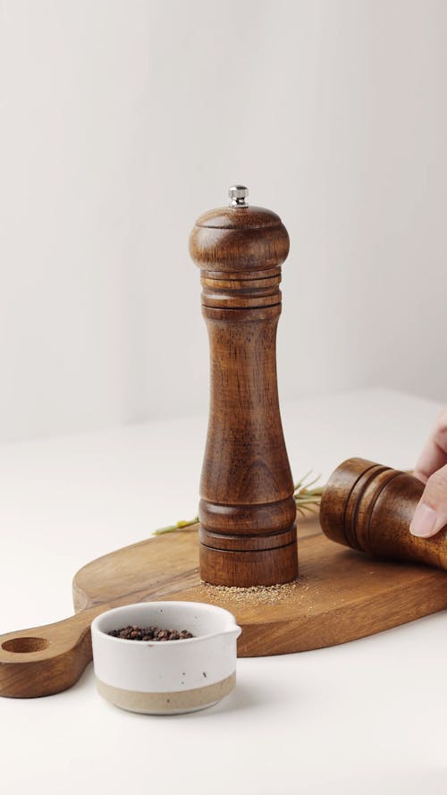 Wooden Pepper Mills on a Chopping Board