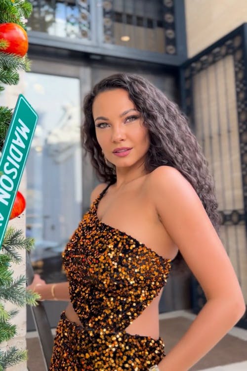 A Female Model Posing in a Gold Sequin Dress