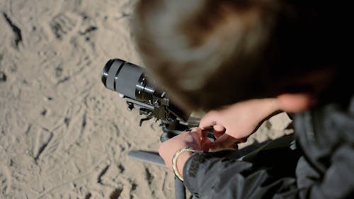 Close up of a Photographer Setting up his Camera on a Tripod