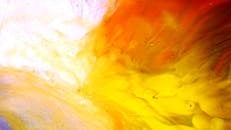 Close up of Red and Yellow Ink Mixing in Water