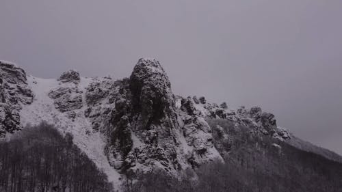 Monochrome Drone Video of a Snowy Mountain 