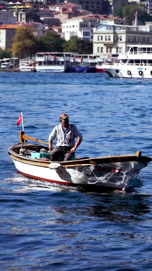 Video Montage of a Fisherman on his Boat near the Coast of Istanbul 
