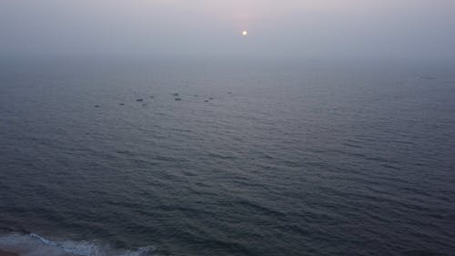 Drone Footage of the Sun Setting over the Ocean 