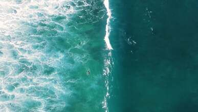 aerial view of a surfer in the ocean
