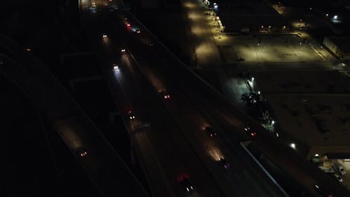 Drone Footage of Night Traffic on a Highway Interchange 