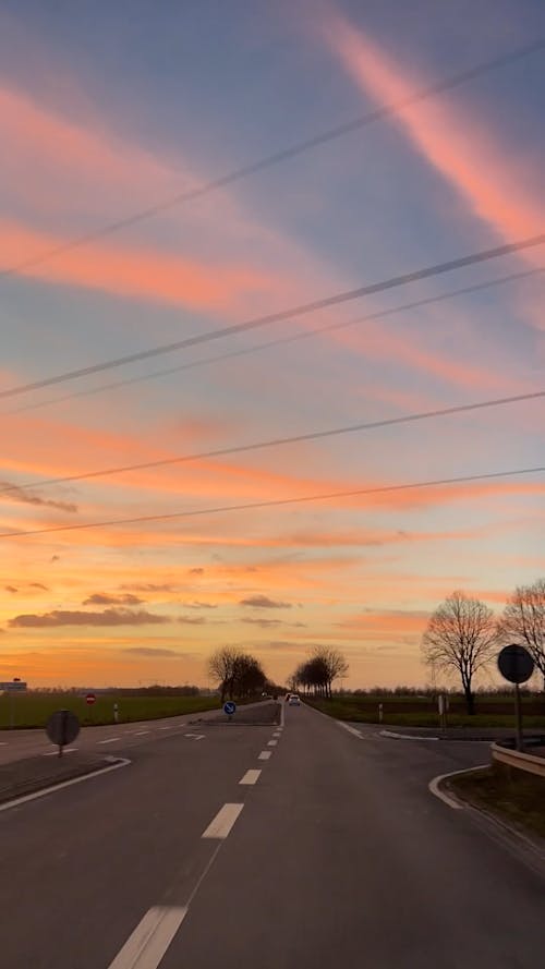 Time Lapse of a Car Driving along the Road at Sunset 