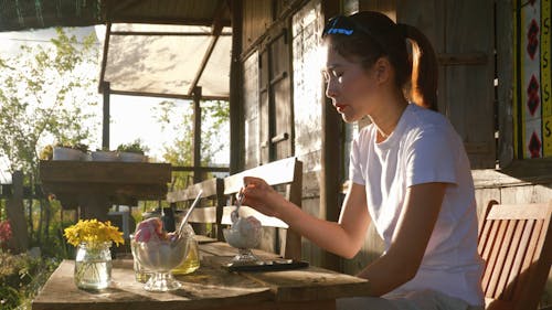 A Woman Eating Ice Cream on the Porch