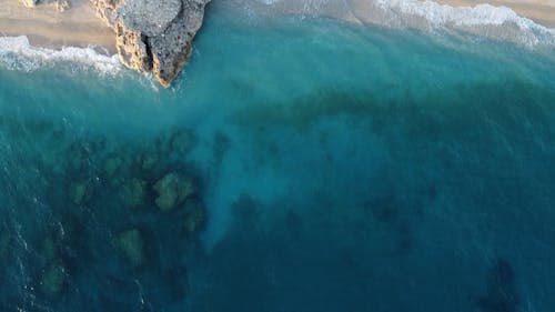 Aerial View of Turquoise Sea Waters and a Cliffed Coast 