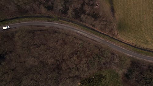 Top View of a White Van on a Country Road 