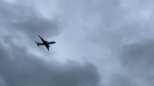 A Plane Flying across a Cloudy Sky 