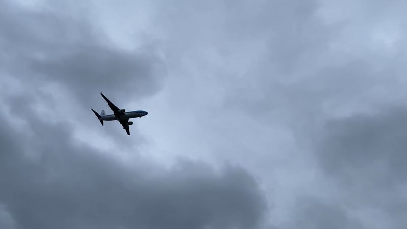 A plane flying through the cloudy sky with a blue sky Free Stock Video ...