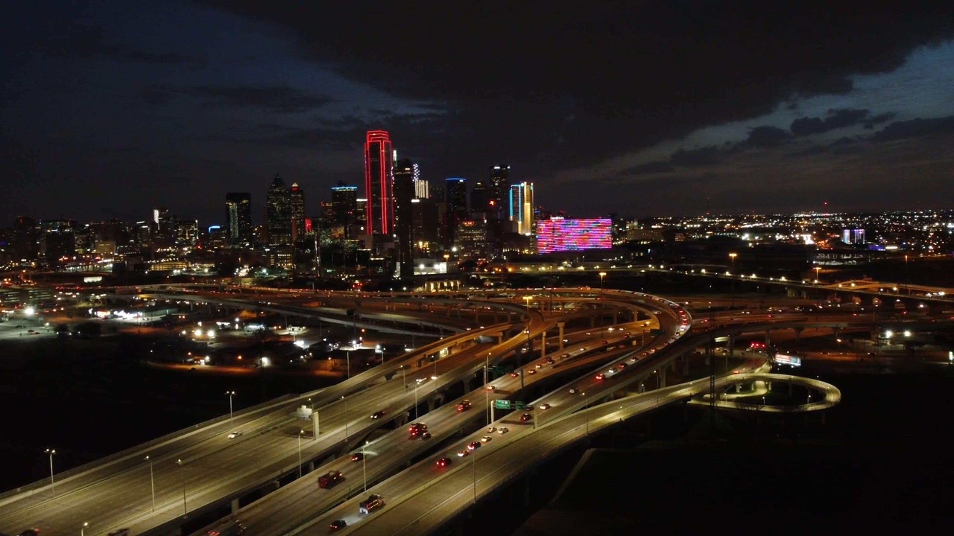 A city skyline at night with a bridge and highway Free Stock Video ...